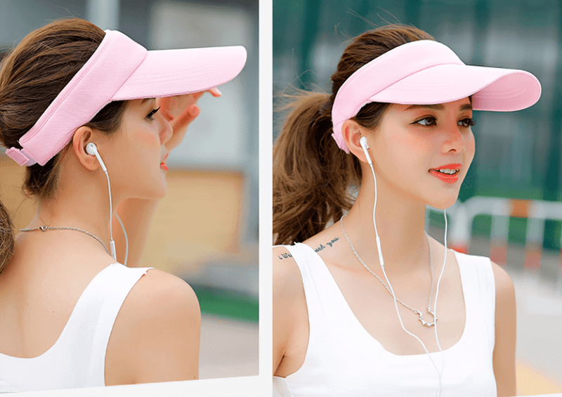 Woman wearing pink UV protection adjustable visor cap outdoors.